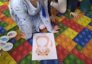 Dziewczynka losuje kartonik z jedzeniem