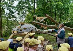 Dzieci oglądają rzeźby dinozaurów