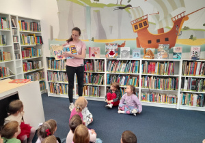 Bibliotekarka pokazuje dzieciom książki