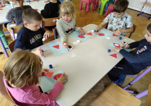 dzieci przyklejają elementy