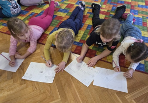 dzieci rysują zimowe piernikowe chatki