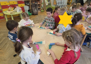 dzieci tworzą aniołki z sizalu