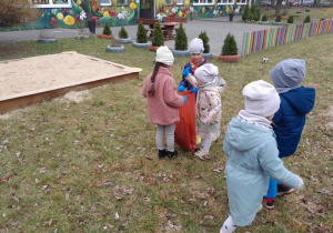 Dzieci porządkują ogród przedszkolny