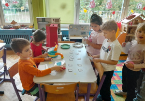 Dzieci "kupują" znaczki na przedszkolnej poczcie