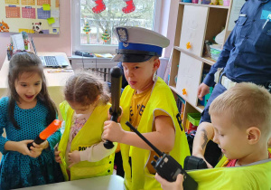 Dzieci oglądają elementy policyjnego wyposażenia